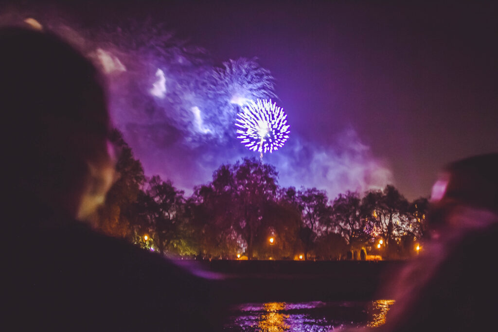 View of fireworks near Battersea Park from a Thames river cruise